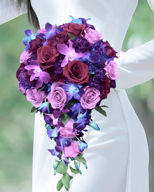Blue Moon Lavender Cascade it is a bridal bouquet with lavender, purple and blue flower blooms for delivery in Las Vegas.
