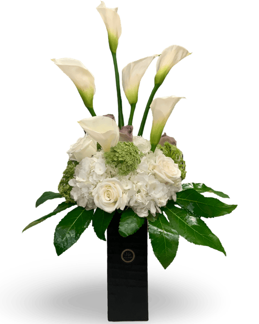 Calla lilies and white roses floral arrangement in a sleek black vase for elegant occasions.