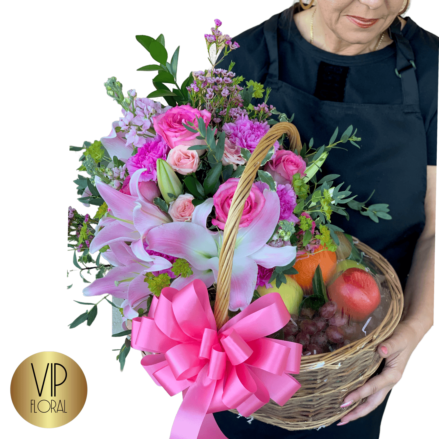 Pink floral arrangement with roses, lilies, and greenery in a wicker basket, decorated with a pink ribbon bow, perfect for special occasions and flower delivery in Las Vegas.
