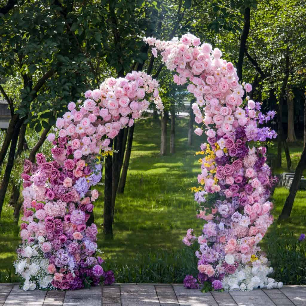 Beautiful pink and purple floral wedding arch perfect for outdoor ceremonies and photo backdrops. Crafted with fresh roses, peonies, and hydrangeas, creating a romantic and picturesque setting.
