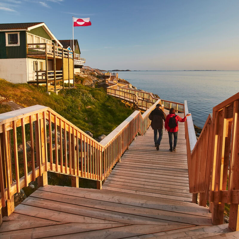 A couple taking a walk on the path along the coastline of Nuuk. Photo by Peter Lindstrom - Visit Greenland