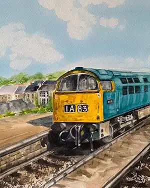 Blue train traveling through picturesque countryside
