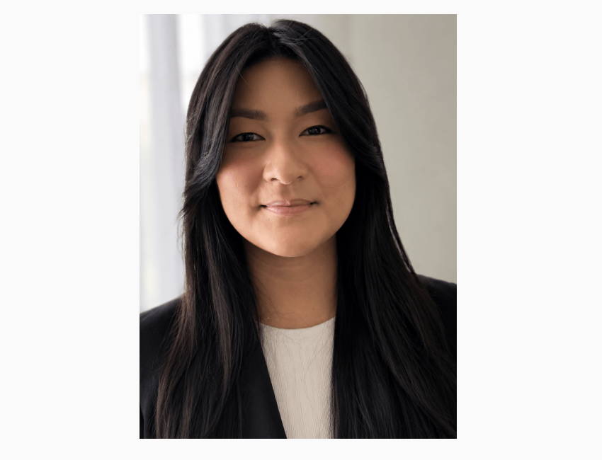 Portrait of a young woman with long black hair and a friendly smile.