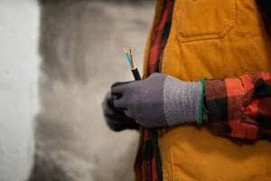 An electrician holding a cable