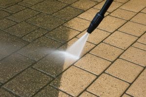 Close up of someone jet washing a patio