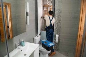 A plumber fixing bathroom pipes