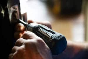 Close up of a handyman fitting a door catch