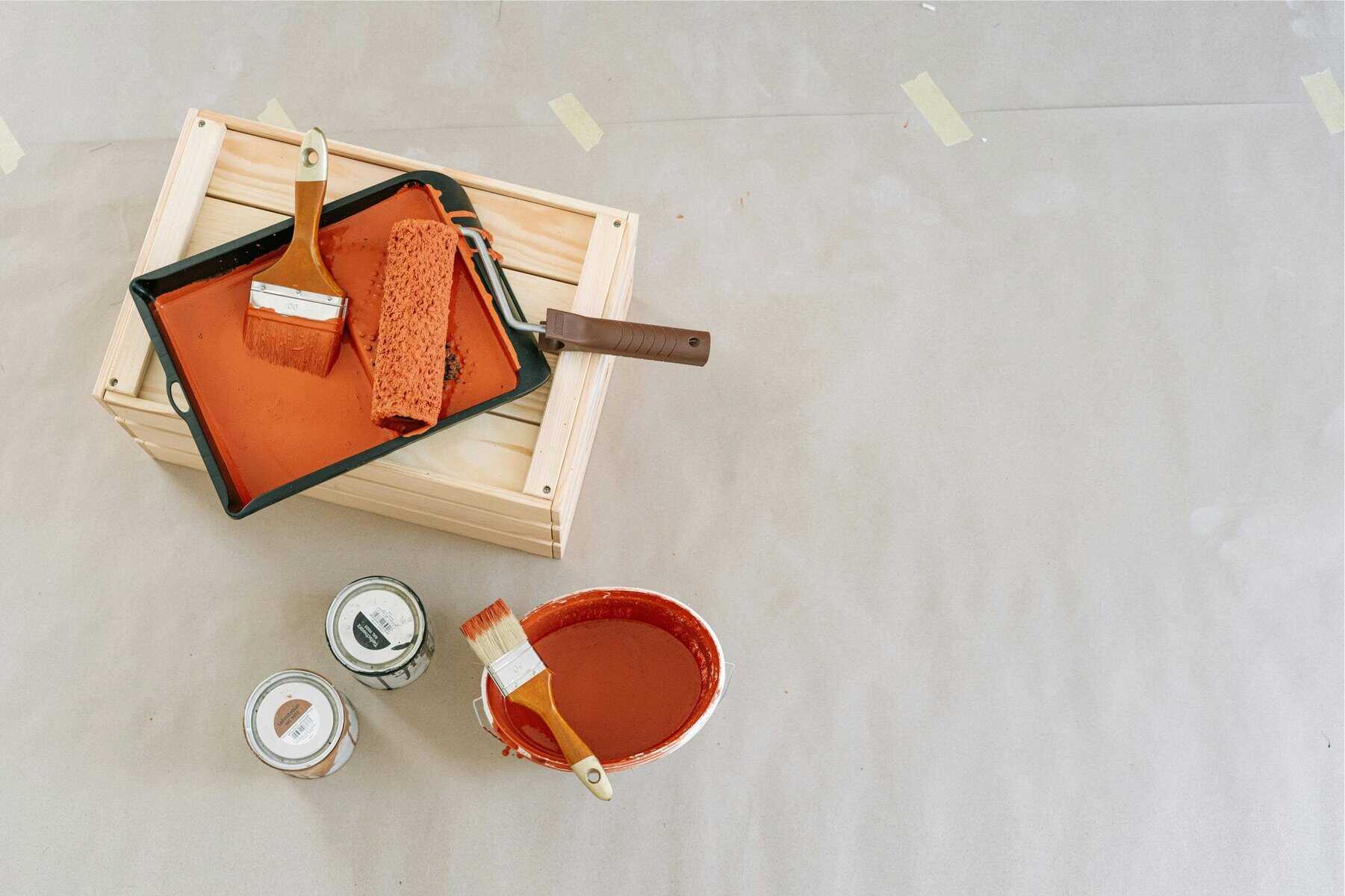 An image of painter and decorating tools and paint tins