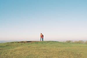 A photo of a couple cuddling on top of Dunstable downs on a sunny autumn day