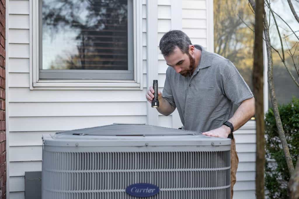 A man inspects an airconditioning unit