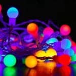 A close up image of a colourful string of outdoor Christmas lights