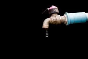 A close up image of a leaking tap