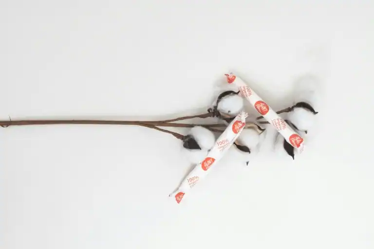 two tampons are on top of a cotton plant representing the 4 menstrual phases