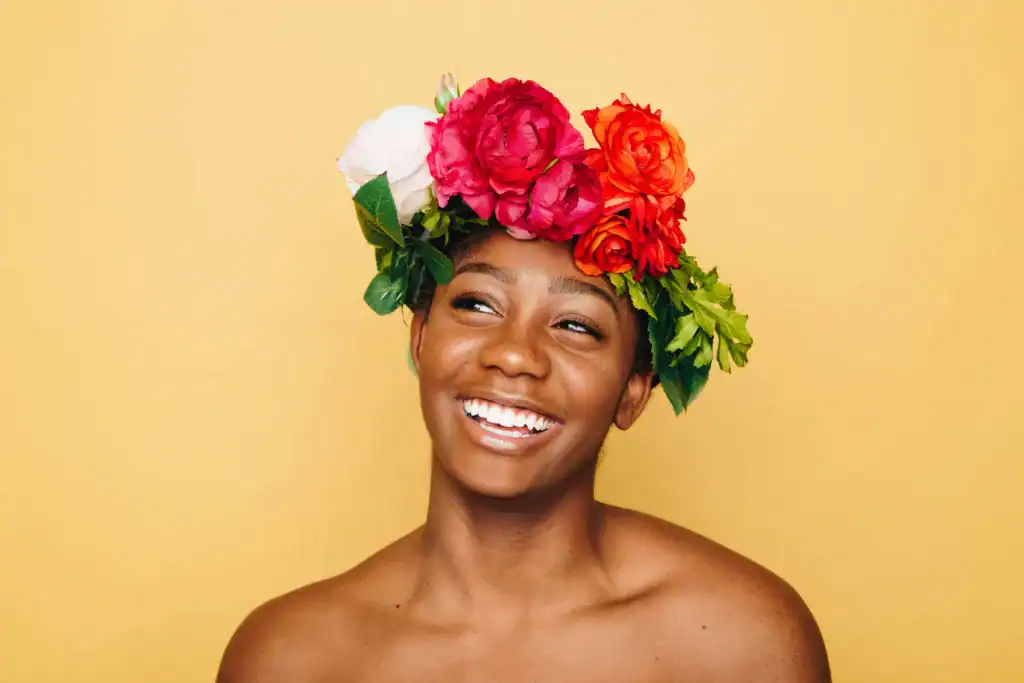 a woman with clear skin during her follicular phase smiles at the camera