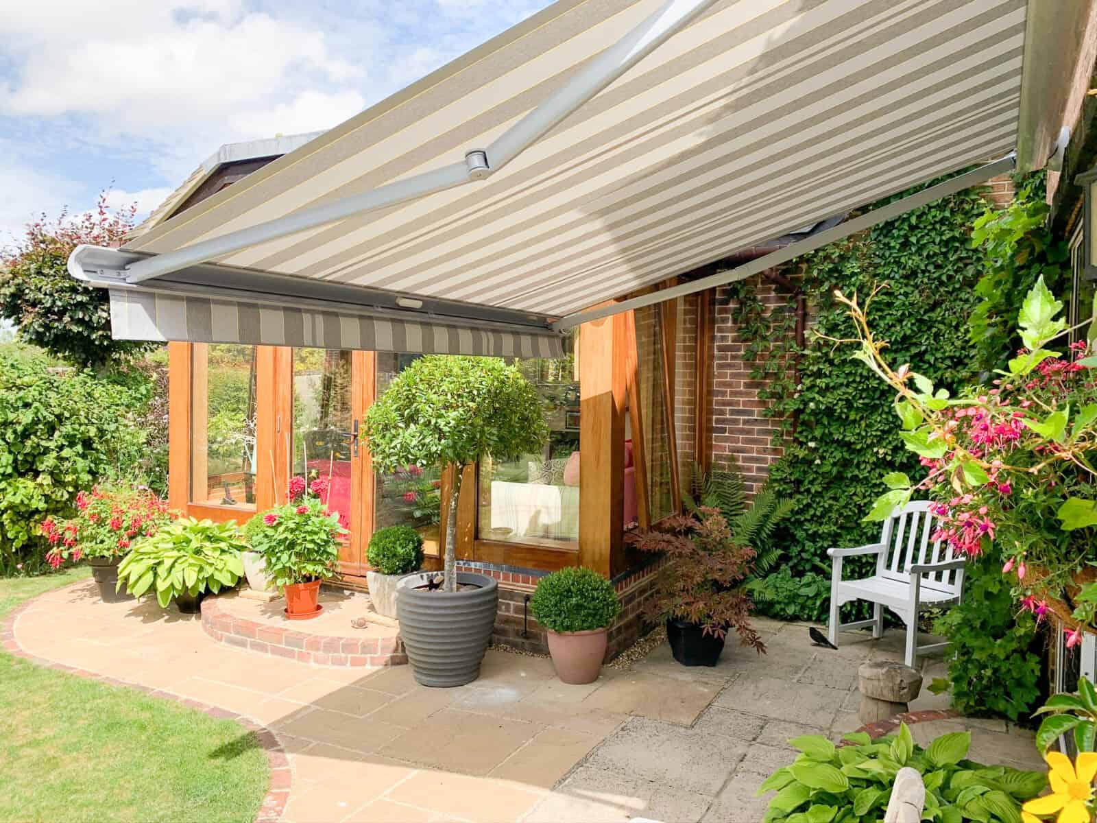 A Somfy Motorised Weinor awning shading a patio in Alresford Hampshire