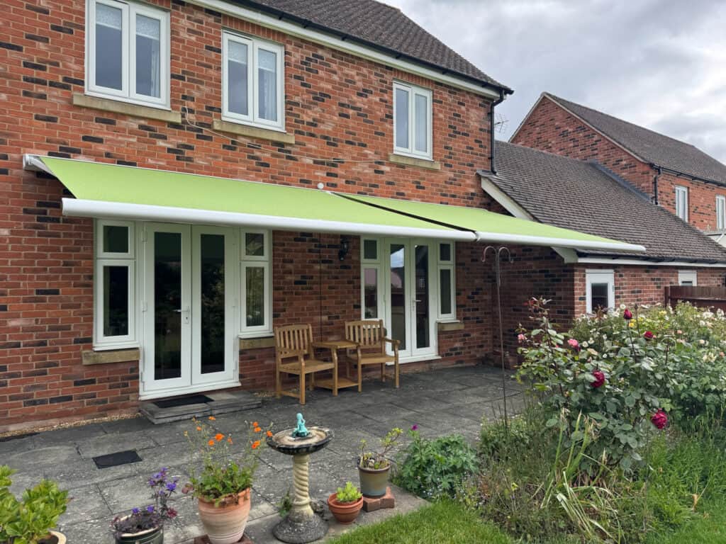 Motorised Weinor awning installed at a home in Andover creating shade over a patio seating area