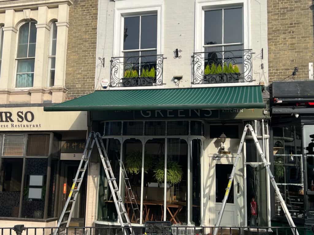 Commercial shopfront awning providing shelter and branding for a Winchester business