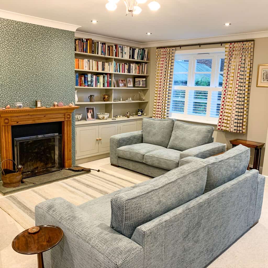 Café shutters paired with existing curtains in a traditional Hampshire home