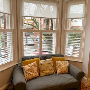 Roman blinds and cafe shutters to sash window in winchester