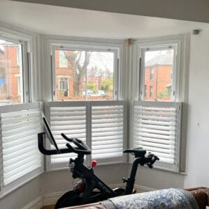 Made-to-measure cafe shutters fitted to a bay window in Hampshire