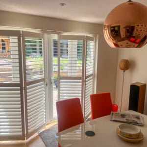 Tracked plantation shutters fitted across a large glazed opening