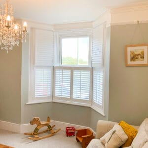tier on tier shutters to bay sash window in living room winchester