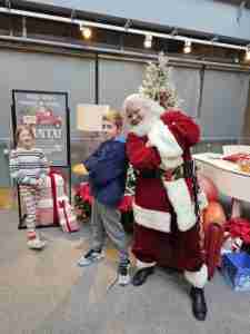 Santa Claus with two children at Christmas event in Milwaukee.