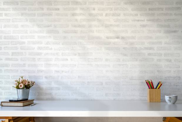Interior design featuring minimalist white wall, clean desk with stationery, and decorative accents for stylish spaces.