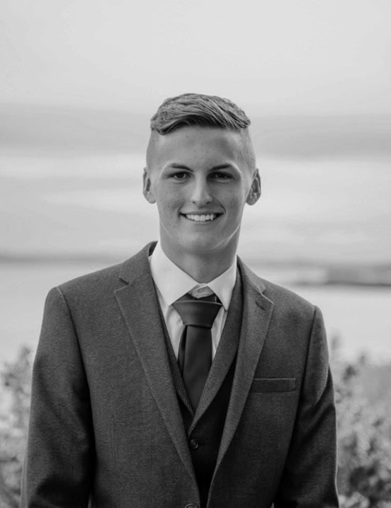 Graduate Architect in Formal Suit at Beach. Professional graduate architect in formal suit smiling on beach with sea background.