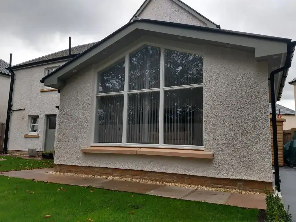 Bright contemporary extension featuring expansive glass panels for natural light.