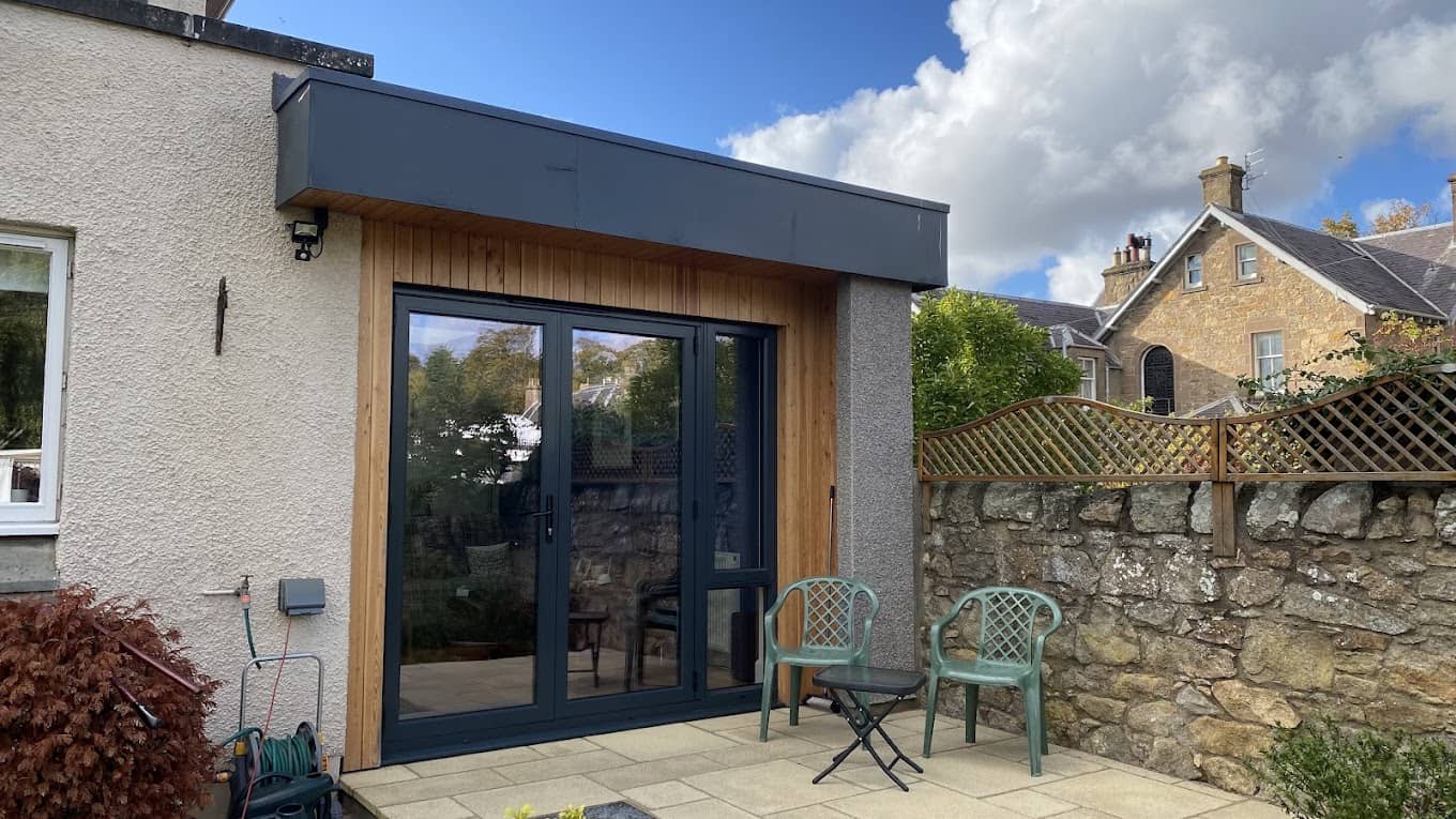 Contemporary garden room with timber cladding and large glass doors, creating a stylish outdoor living space.