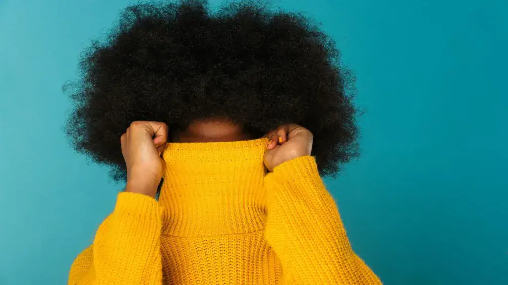 Femme avec une coiffure afro volumineuse, exemple d'une routine capillaire pour cheveux crépus réussie.