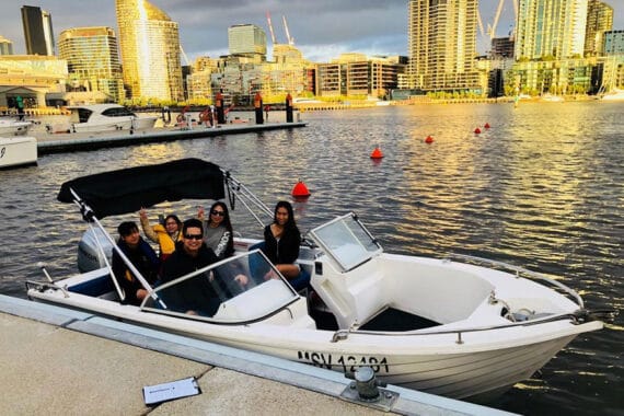 Group of people enjoying a boat ride in Melbourne harbor.