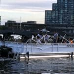 Passenger boat on Melbourne river with city skyline in background.