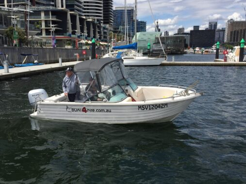 Person on boat during hands-on boat lesson in Melbourne harbor.