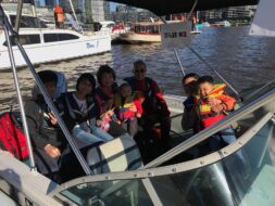 Corporate staff enjoying a private party boat hire Melbourne cruise on the Yarra River at sunset