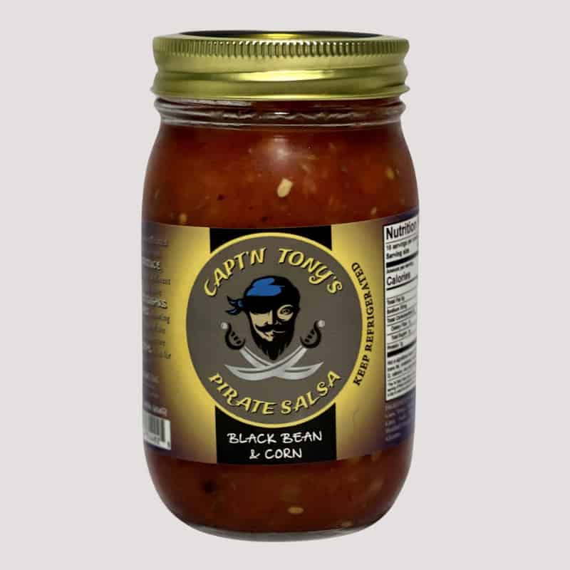 Jar of homemade black bean and corn salsa with pirate-themed label and gold lid.