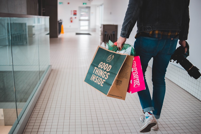 Shopper carrying bags through a shopping centre
