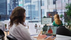 Businesswoman using laptop in a contemporary Dubai office.