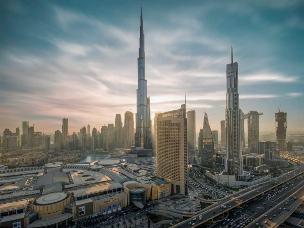 Dubai skyline featuring Burj Khalifa and modern skyscrapers at sunset.