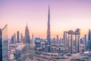 Dubai skyline featuring Burj Khalifa at sunset, modern skyscrapers, and cityscape.