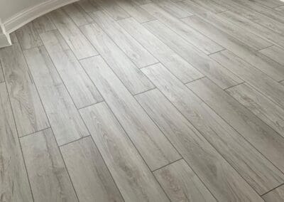 Light wooden laminate flooring in a room.