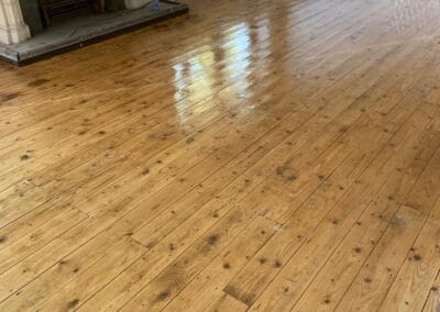 Polished wooden floor in empty living room.