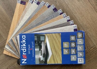 Nordikka flooring samples displayed on wooden floor.