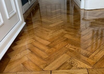 Polished herringbone wooden floor in hallway