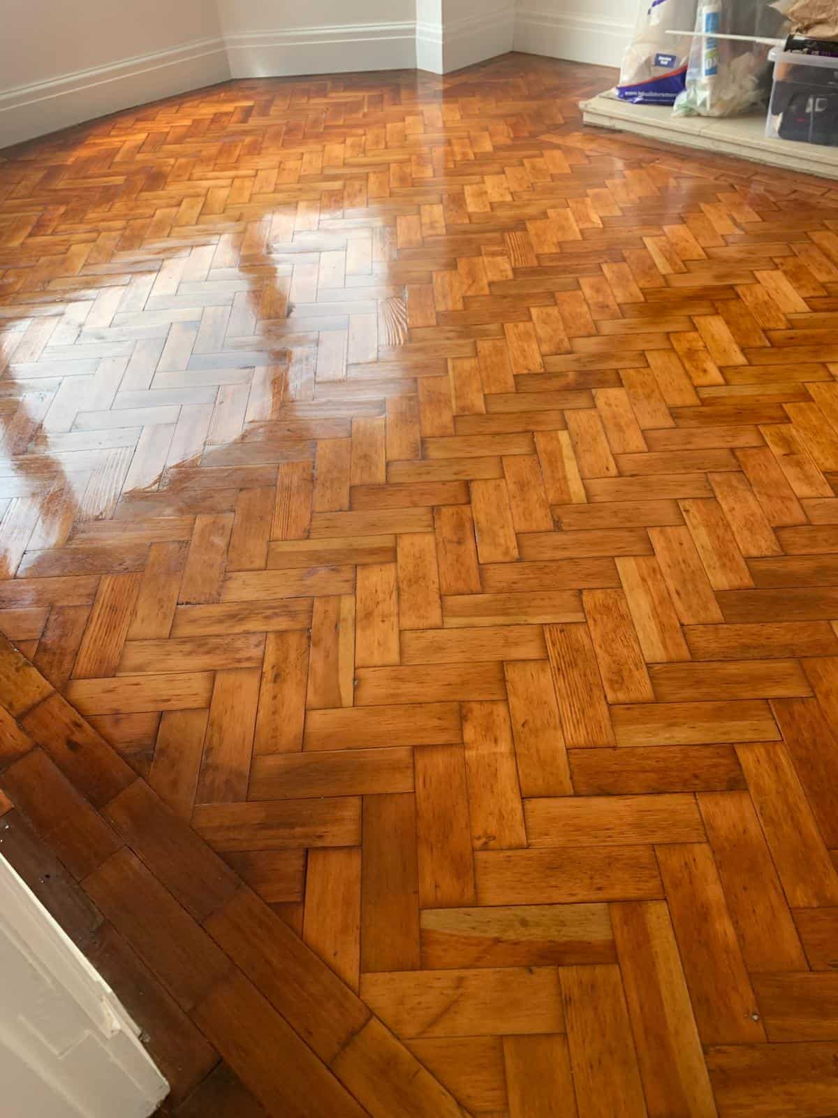 Polished wooden parquet floor in an empty room