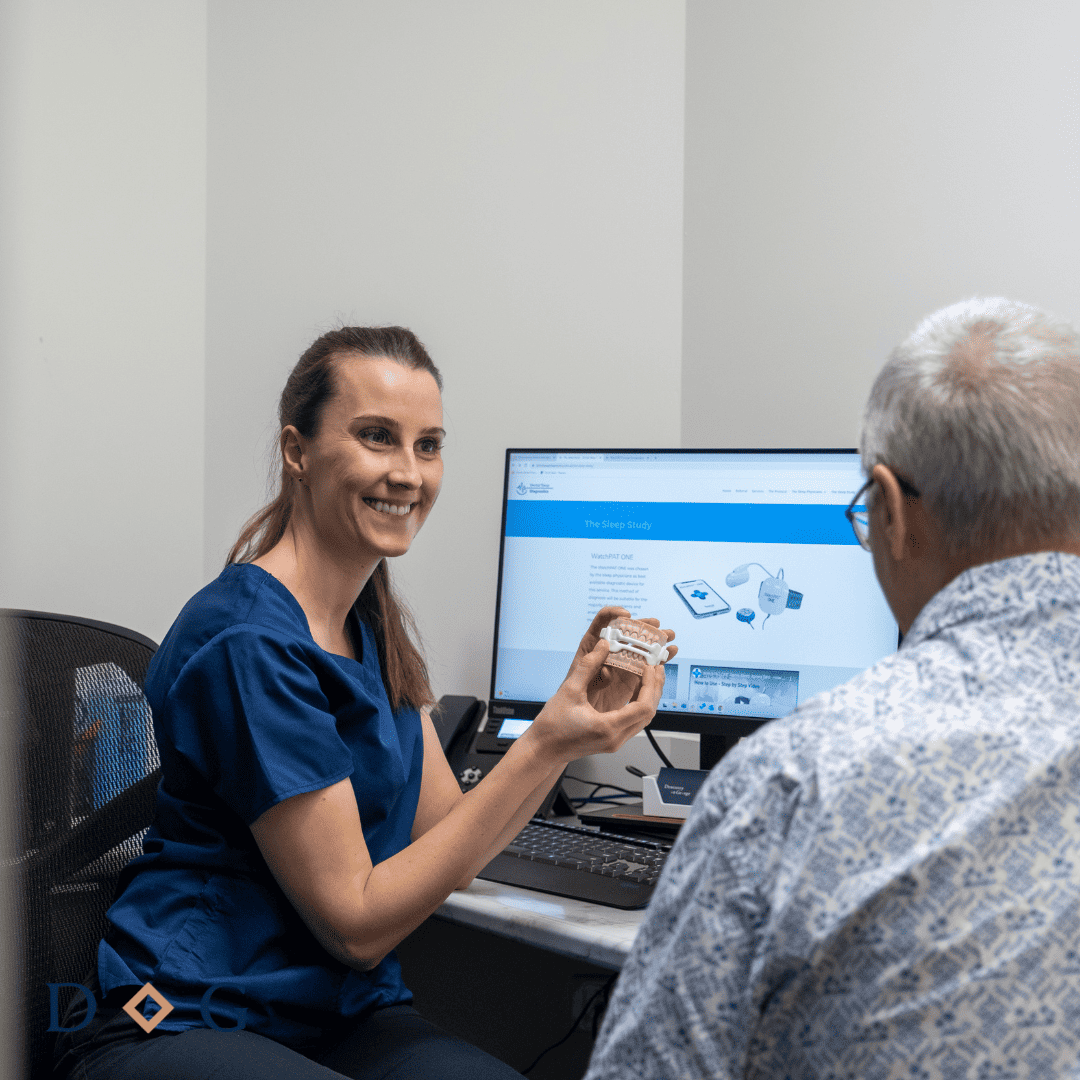 brisbane cbd dentist showing patient a custom-fitted mouthguard