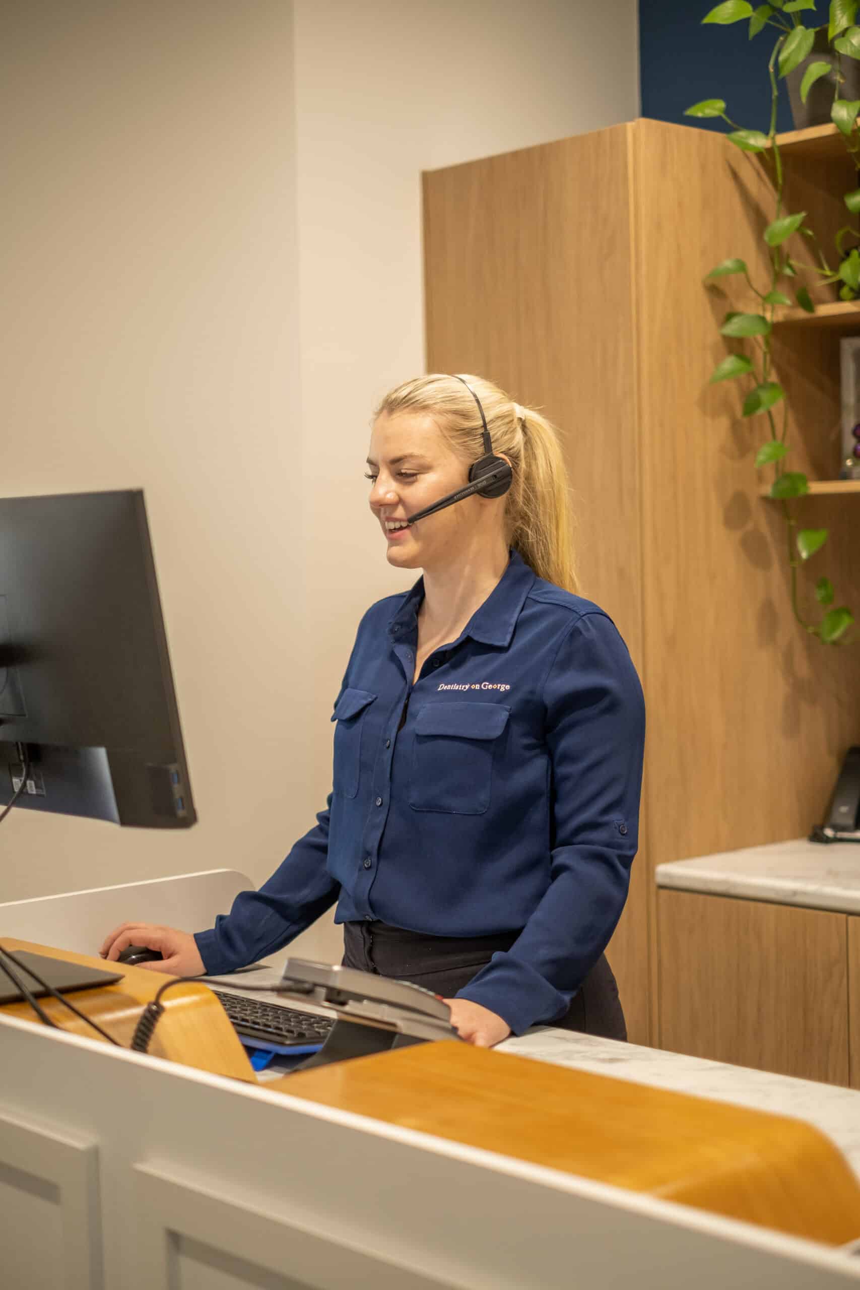 Receptionist at Brisbane CBD Dental practice coordinating patient appointments