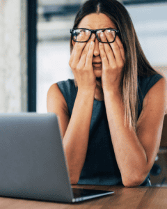 lady tired at desk trying to work