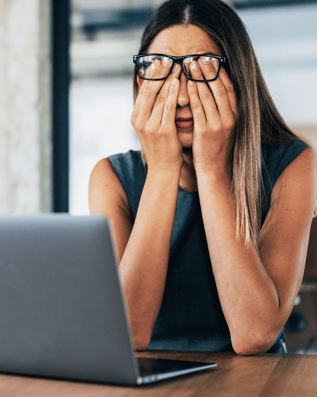 lady tired at desk trying to work